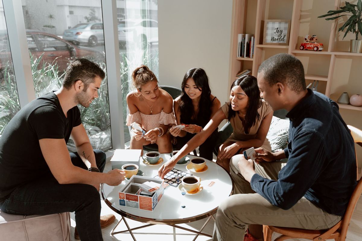 A group of friends sitting around a table together